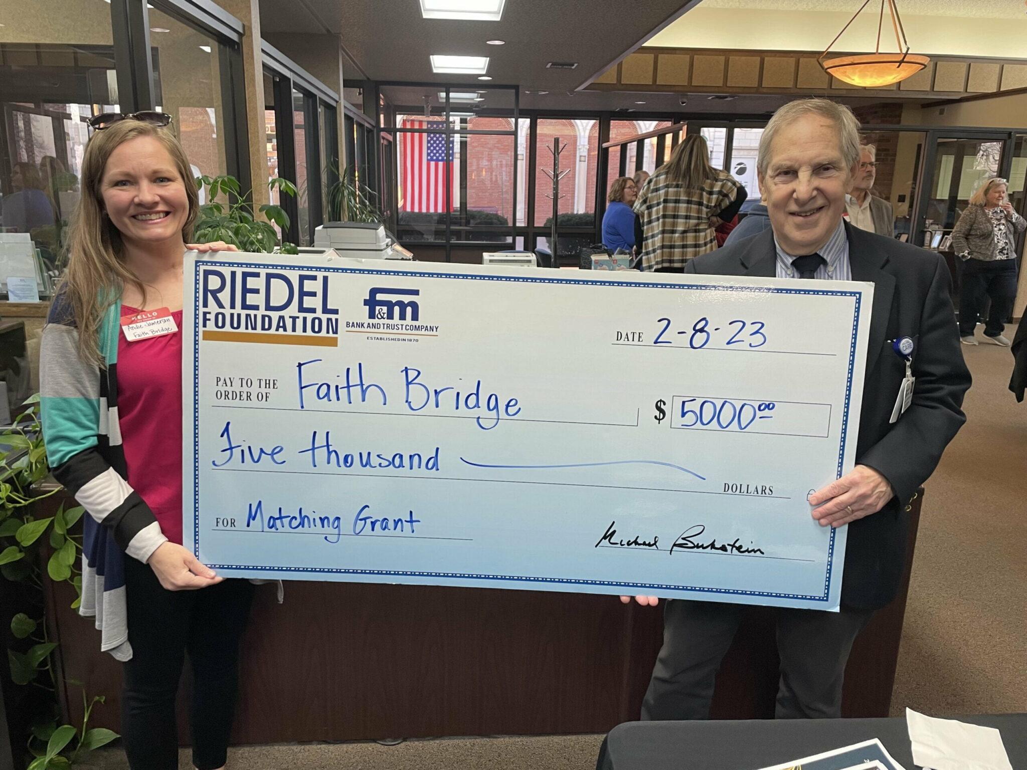 Riedel Foundation Lead Trustee Michael Bukstein presents a $5,000 matching grant to Faith Bridge Director Andie Jamerson.