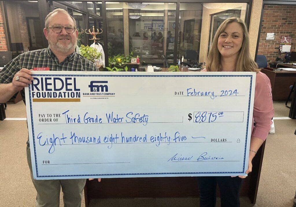 Riedel Foundation Michael Gaines presents a grant to Kelly Colley with the Hannibal YMCA.
