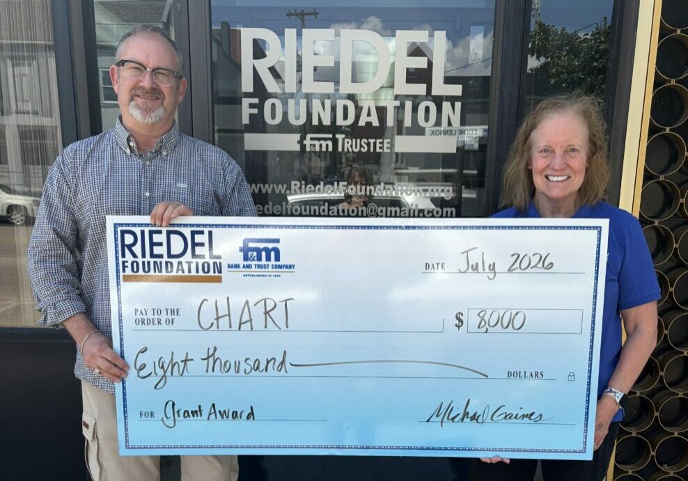 Riedel Foundation Trustee Michael Gaines presents a grant award to Sandra Ahlum with the CHART Teen Task Force.