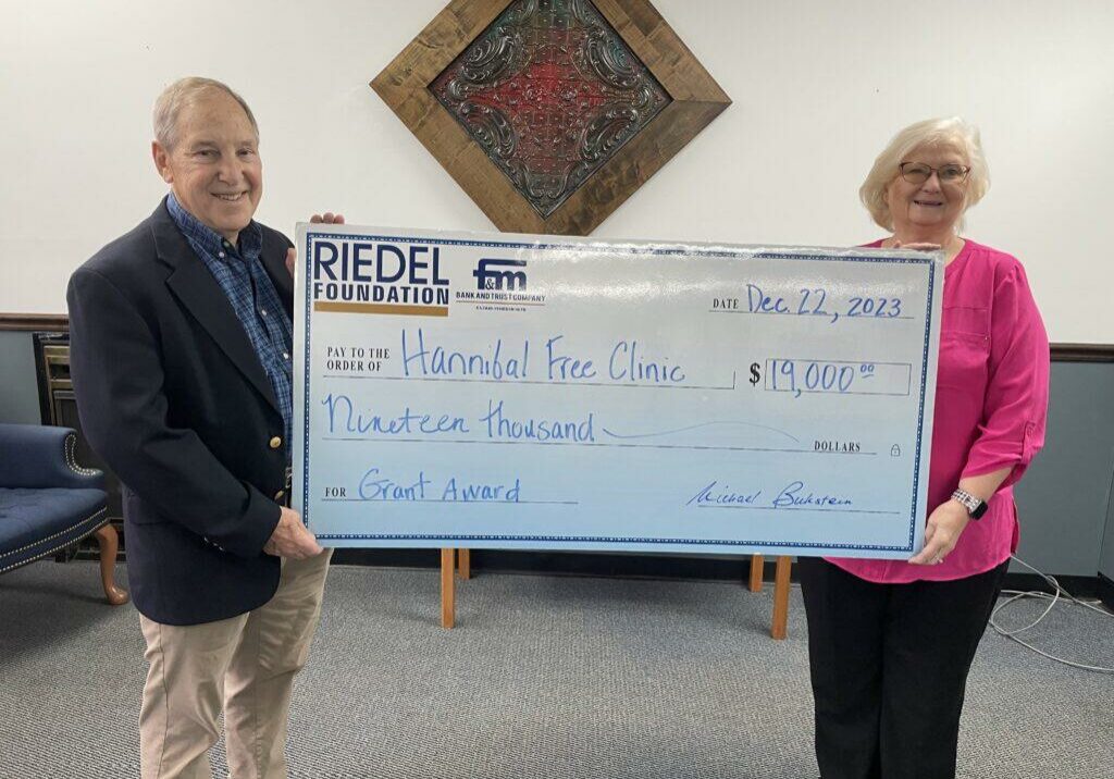 Riedel Foundation Lead Trustee Dr. Michael Bukstein presents a grant award to Hannibal Free Clinic Director Sharon Webster. 