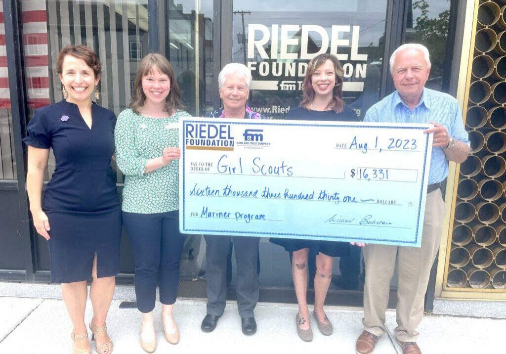 Erin Vlasaty, Girl Scout Fund Development Manager; Jill Dameron, GS Database Manager; Robbie Hagan, Mariner Skipper; Kristin Fasnacht, GS Community Engagement Manager; and Bill Criagmiles, Riedel Trustee at a check presentation for the Girl Scout Mariners.