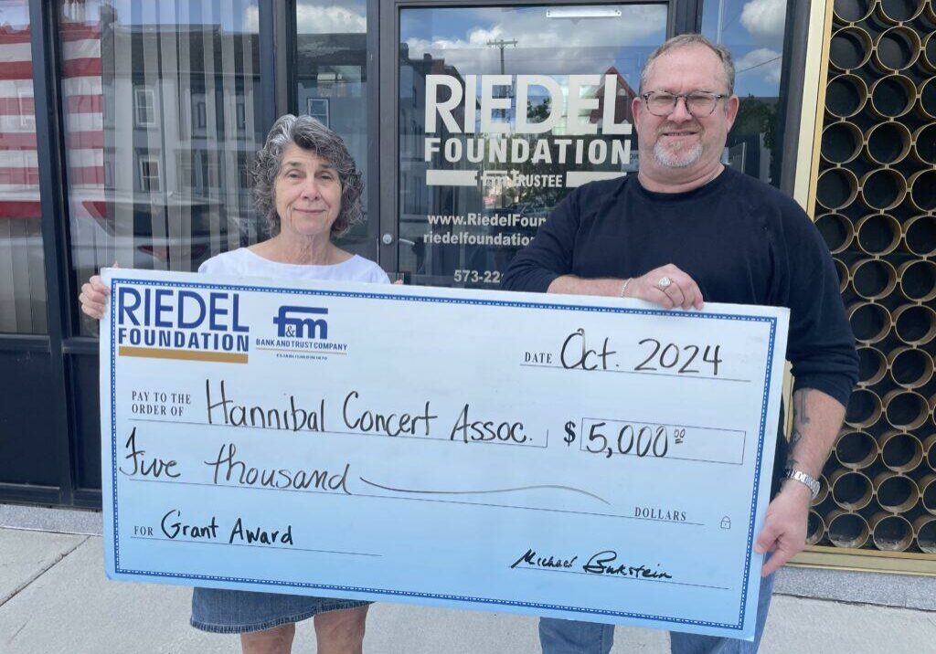 Riedel Foundation Trustee Michael Gaines presents a grant award to the Hannibal Concert Association President Sara North