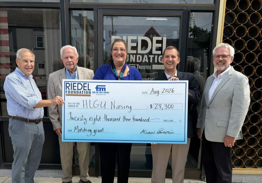 Riedel Trustees Michael Bukstein and Bill Craigmiles present a $28,300 matching grant to Dr. Ginger Wolgemuth, Director of the Craigmiles School of Nursing, HLGU President Dr. Robert Matz, and Dr. Ray Carty, VP for Institutional Advancement and Marketing at HLGU.