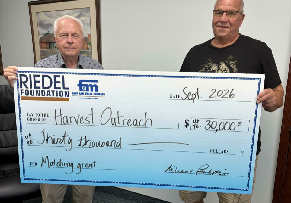 Riedel Foundation Trustee Bill Craigmiles presents a $30,000 matching grant offer to Pastor Larry Hinds, with Harvest Outreach Ministries in Hannibal.