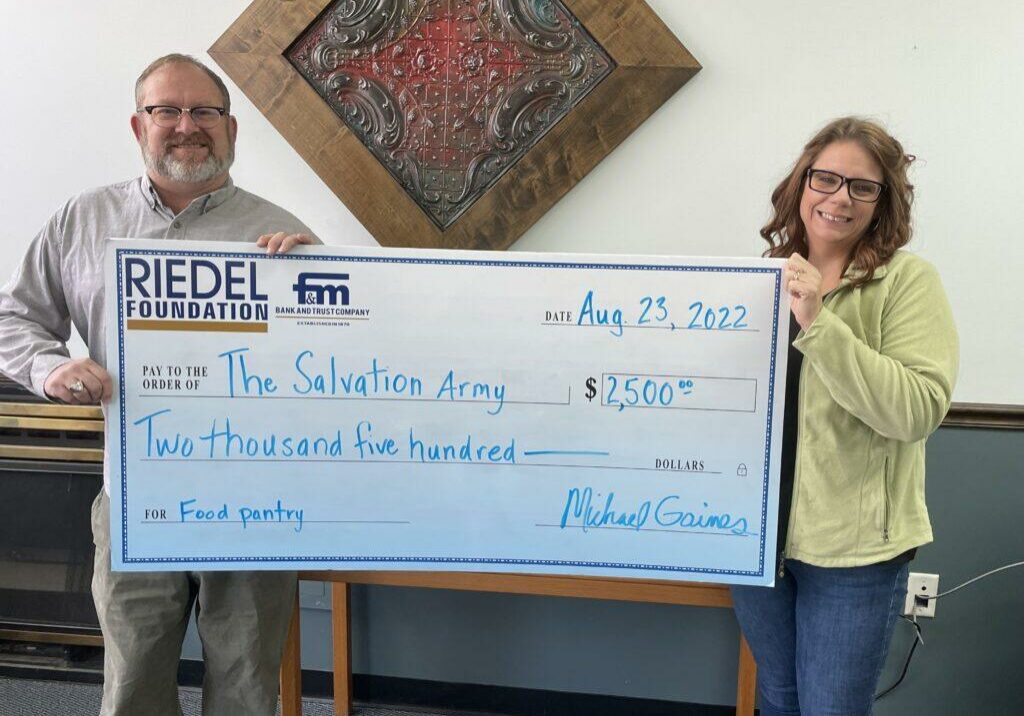 Riedel Trustee Michael Gaines presents a $2,500 check to Amanda Bowen, Family Caseworker with The Salvation Army of Hannibal.