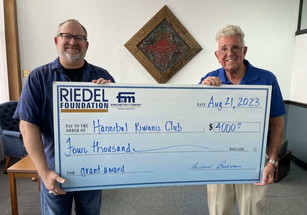 Riedel Foundation Trustee Michael Gaines presents a grant to Kiwanis Club Member Paul Buckman.