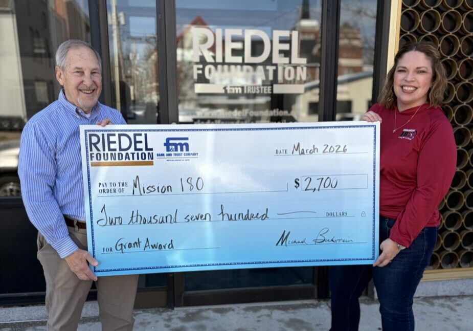 Riedel Foundation Lead Trustee Michael Bukstein presents a grant award to Mission 180 Board President Stephanie Morris.