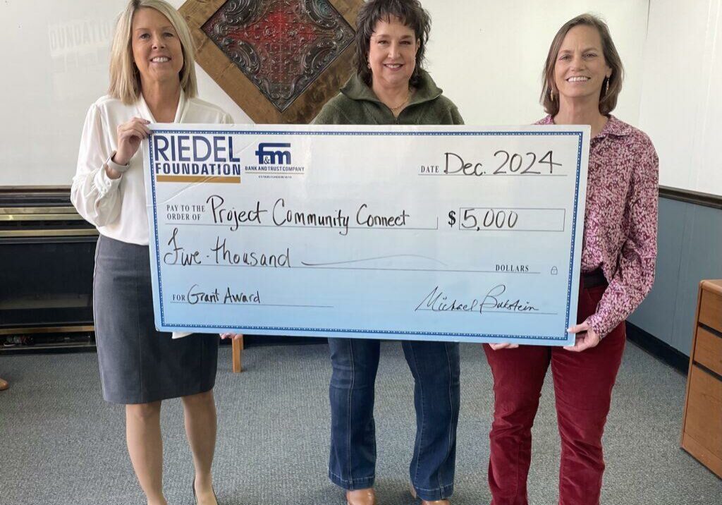 Riedel Trustee April Baldwin presents a $5,000 grant award to Project Community Connect.
