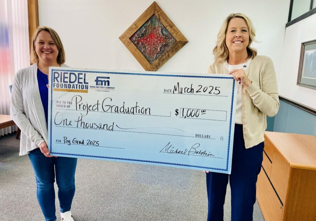 Project Graduation 2025 co-chair Anna Lemon accepts a grant award from Riedel Foundation Trustee April Baldwin.