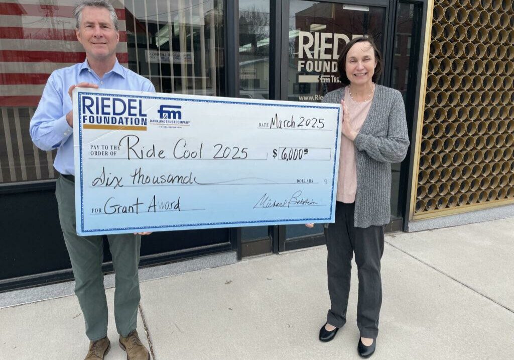 Riedel Trustee Paul Richards presents a $6,000 check to Dr. Susan Meidl with Ride Cool.