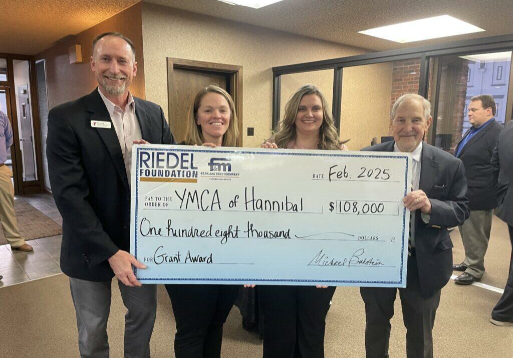 Riedel Trustee Michael Bukstein presents a grant award to the YMCA of Hannibal.
