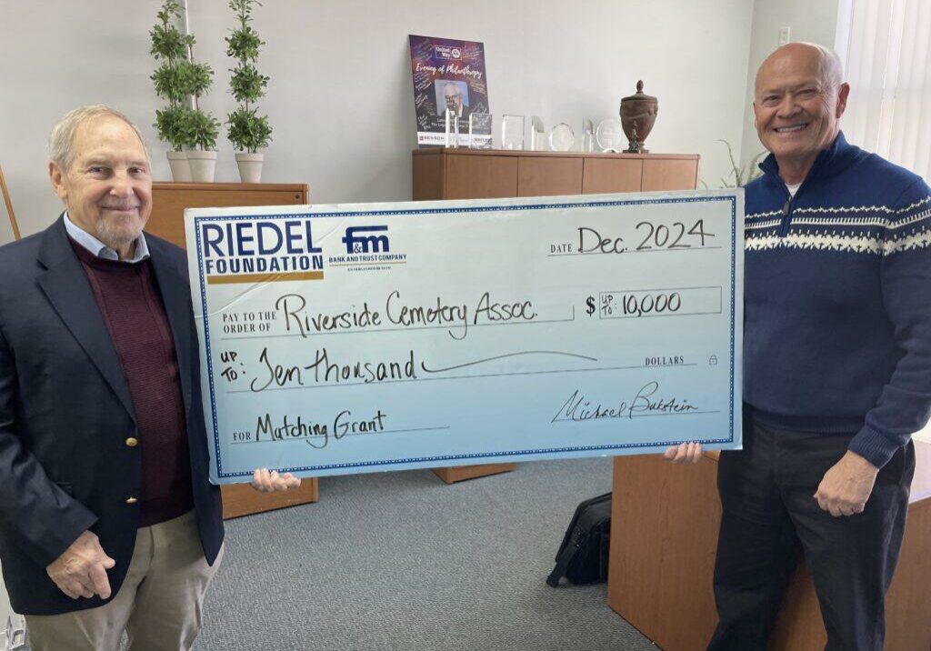 Riedel Foundation Trustee Dr. Michael Bukstein presents a matching grant to Jim Youse, president of the Riverside Cemetery Association.
