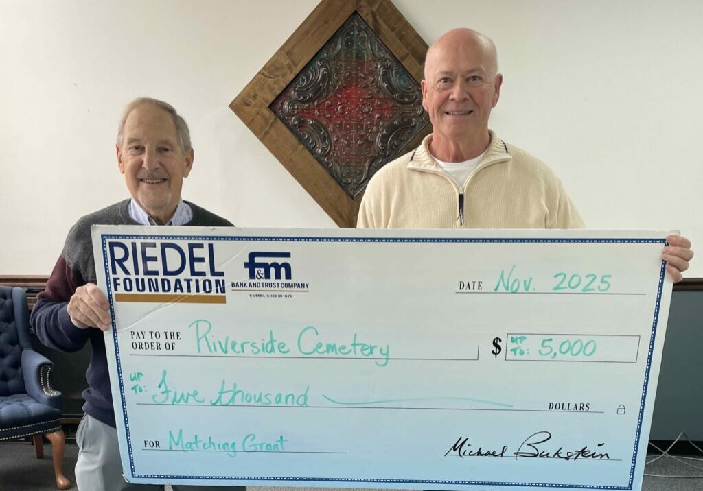 Riedel Foundation lead trustee Michael Bukstein presents a $5,000 matching grant opportunity to Jim Youse, president of the Riverside Cemetery Association.