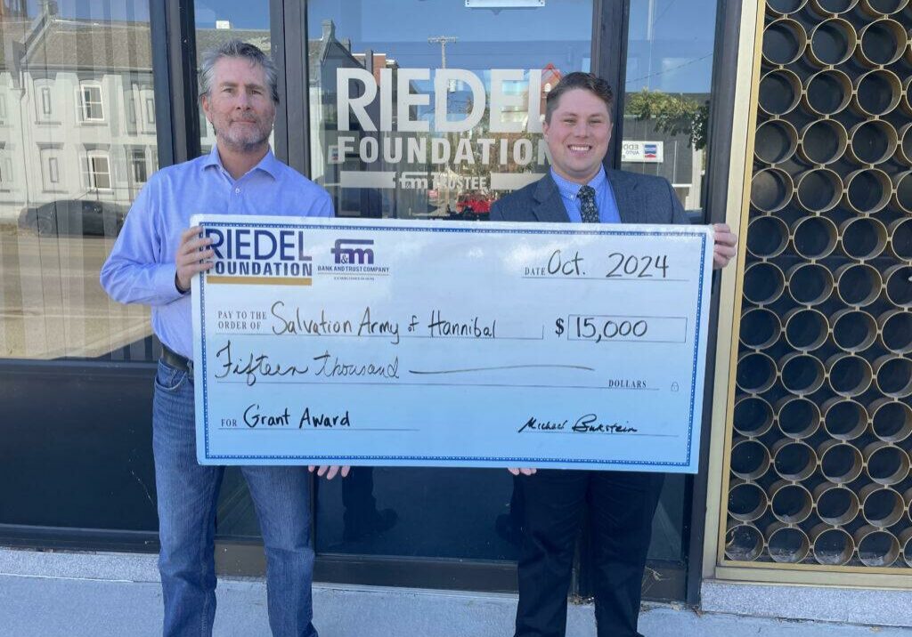 Riedel Foundation Trustee Paul Richards presents a $15,000 grant award to Jake Reed with the Salvation Army of Hannibal.
